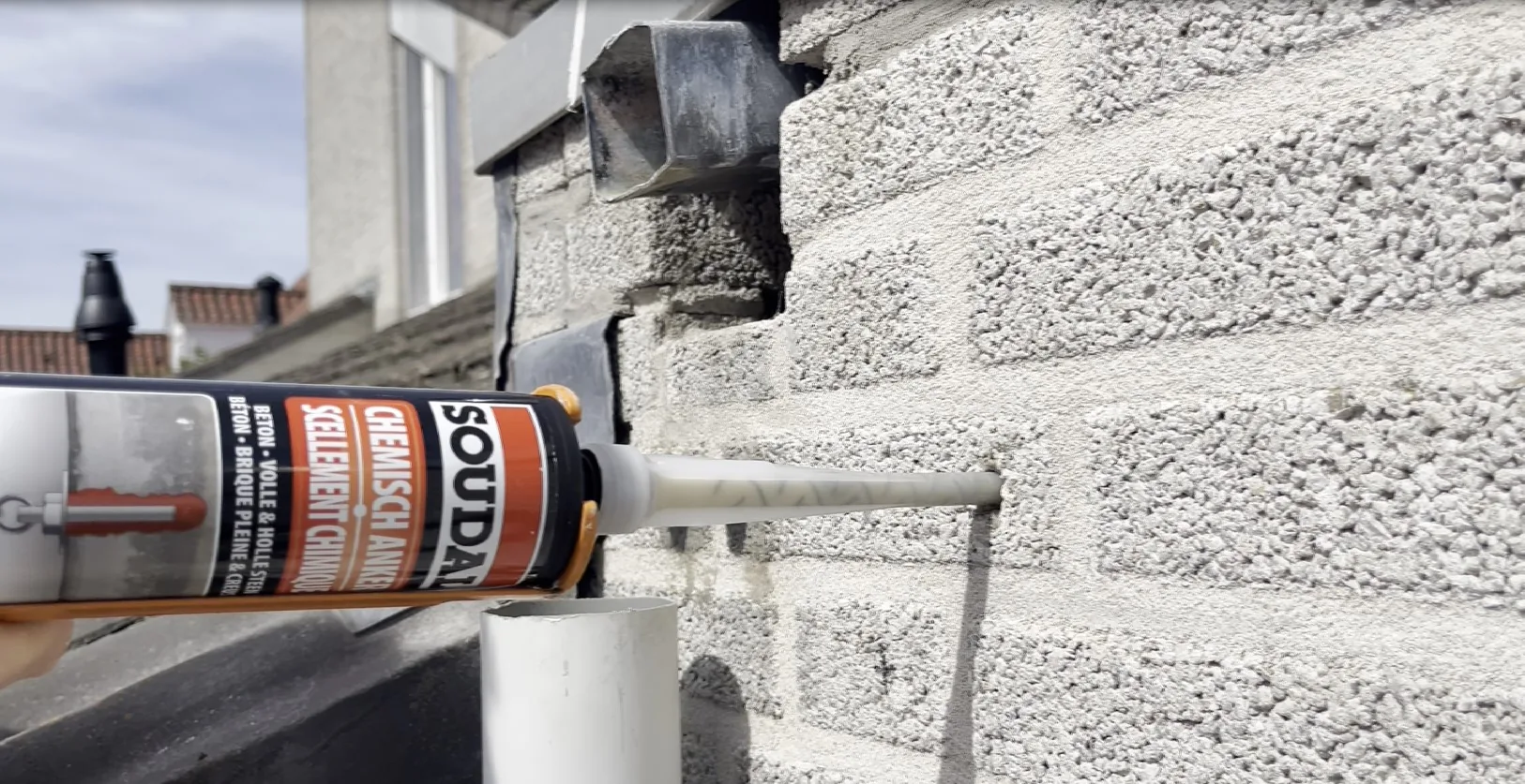 Injecting Soudal chemical anchoring resin into a hollow masonry block