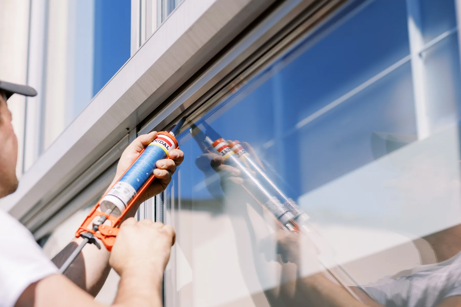 Applying Silirub silicone at an exterior window glazing joint