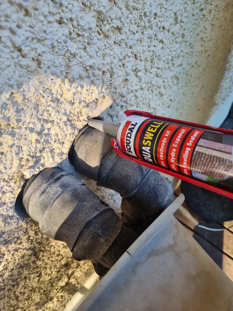 Applying Aquaswell around a geothermal heating pipe penetration