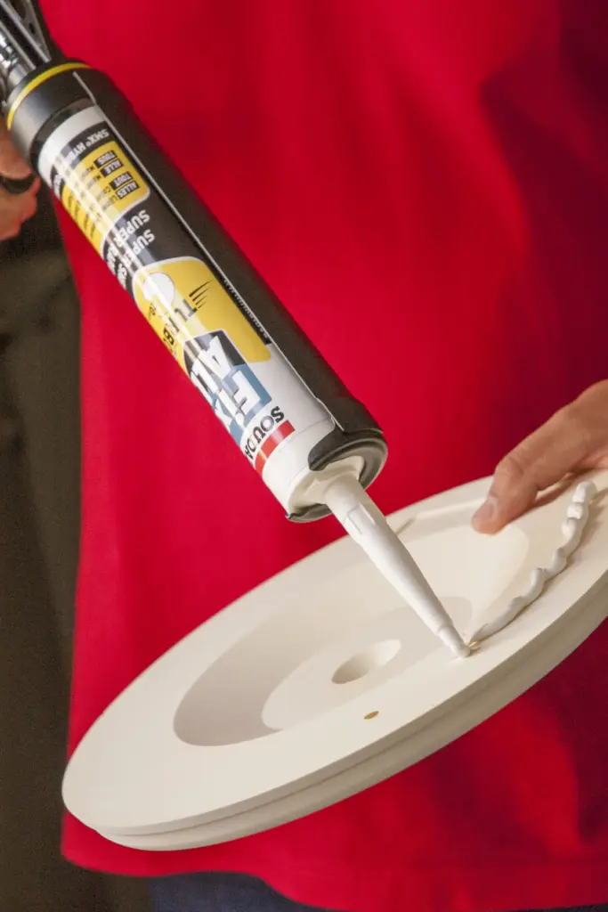 Applying Fix All Turbo to the back of a decorative ceiling rose